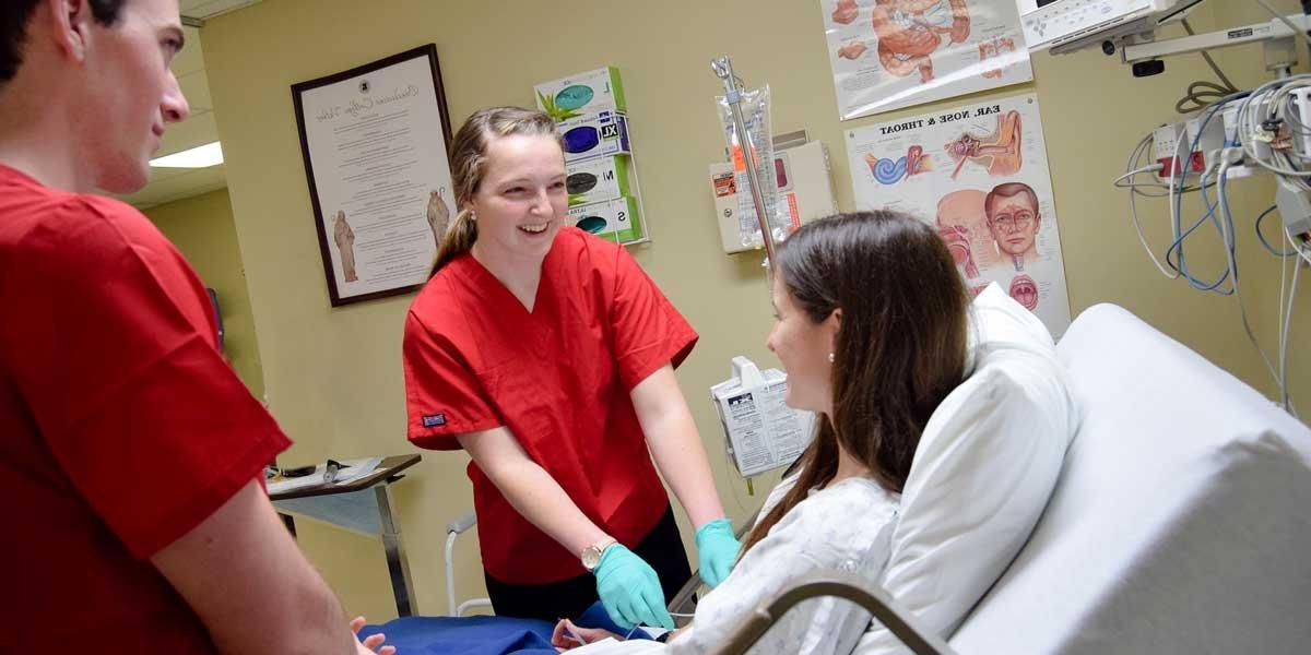 Nursing students practice in a simulation room